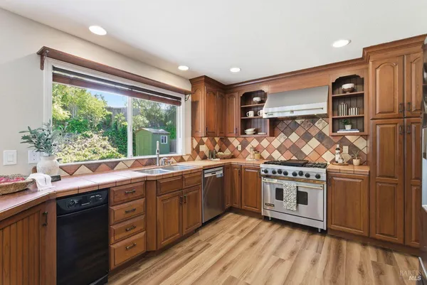 a kitchen with a sink stove and cabinets