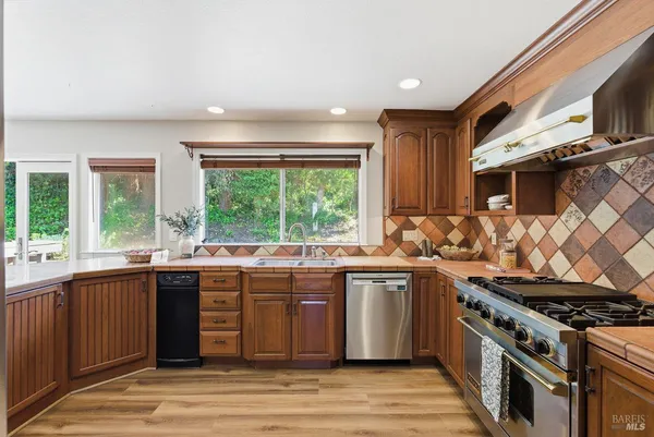 a living room with furniture and large windows