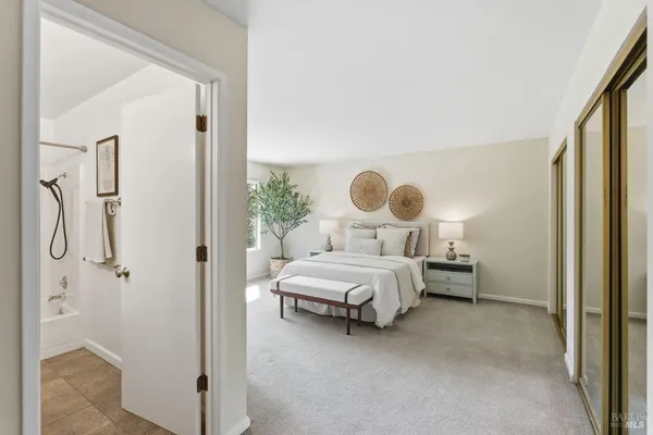 a bedroom with a bed and a painting on the wall