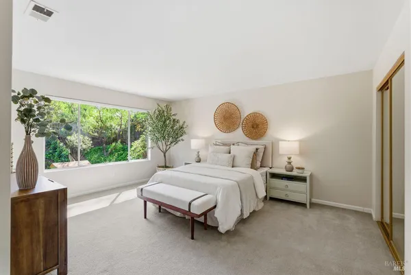 a bedroom with a bed and a window