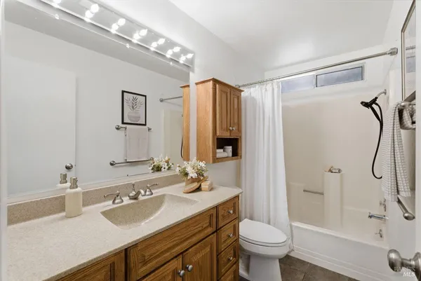 a bedroom with two beds and a potted plant