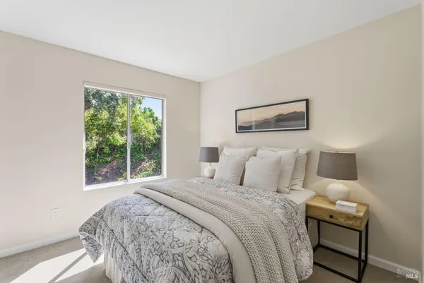 a bedroom with two beds and chair