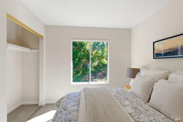 a bedroom with a bed and a lamp