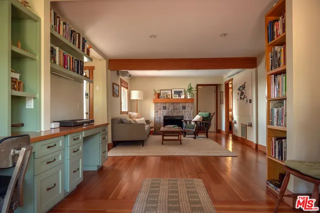 a living room with furniture a dining table and chairs with wooden floor