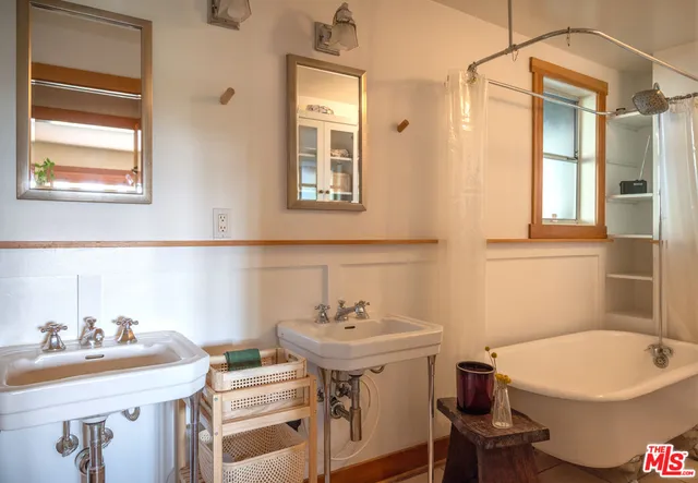 a bathroom with a sink toilet and a mirror