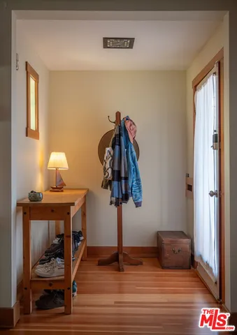 a view of entryway and hall with wooden floor