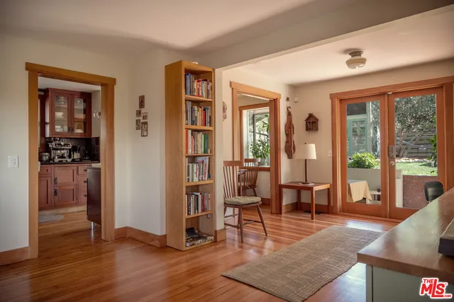 a living room with furniture and large windows