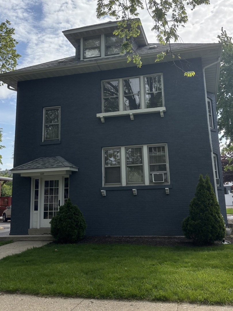 115 North Myrtle Avenue, Unit 2F Elmhurst, IL 60126 - Photo 1 of 14 a front view of a house with a garden
