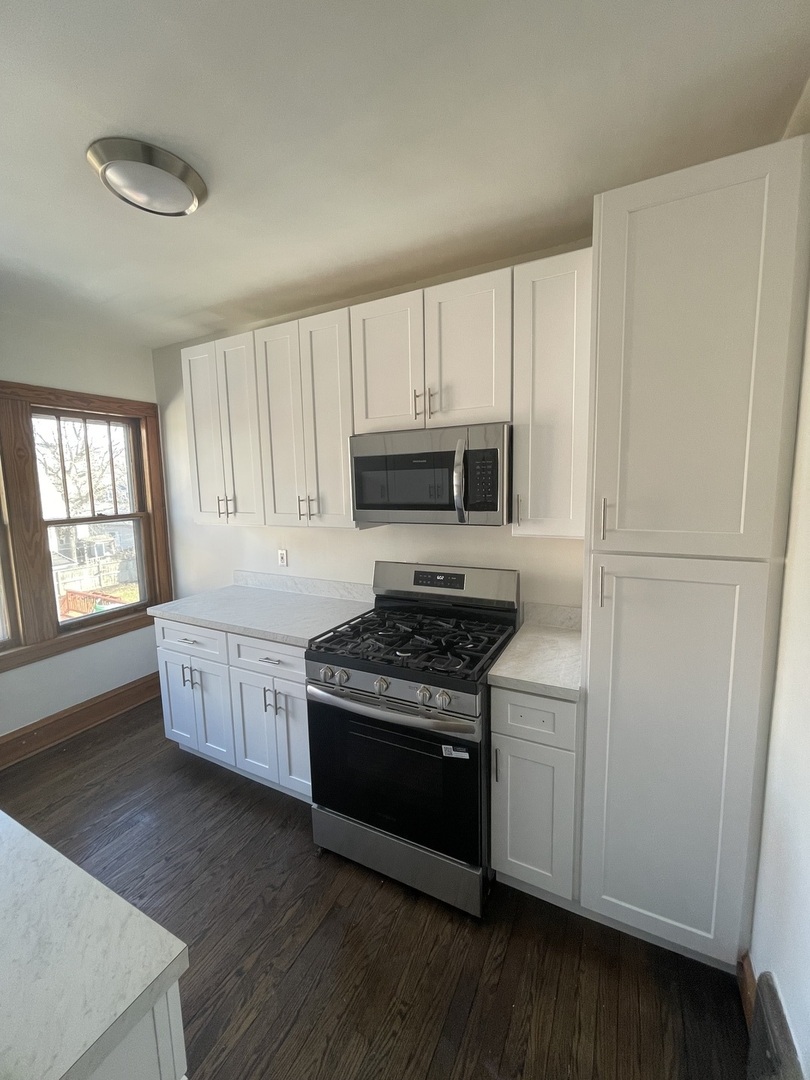 115 North Myrtle Avenue, Unit 2F Elmhurst, IL 60126 - Photo 11 of 14 a kitchen with granite countertop white cabinets and white appliances