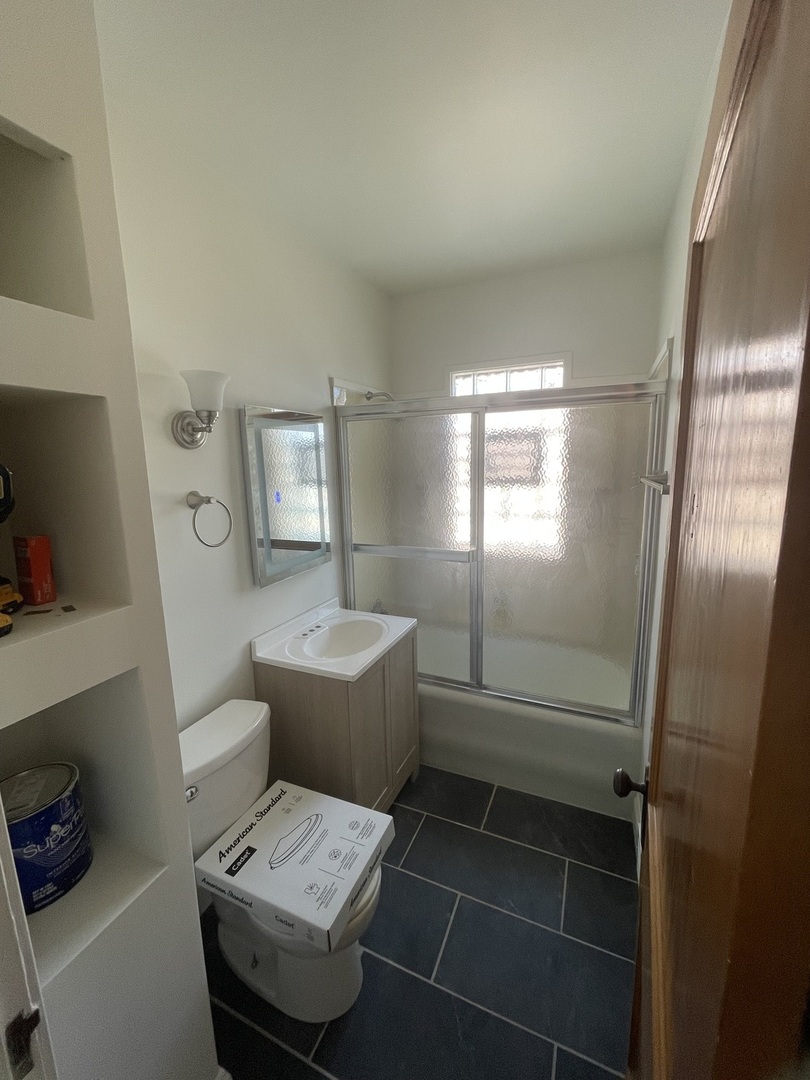115 North Myrtle Avenue, Unit 2F Elmhurst, IL 60126 - Photo 12 of 14 a bathroom with a sink toilet and shower
