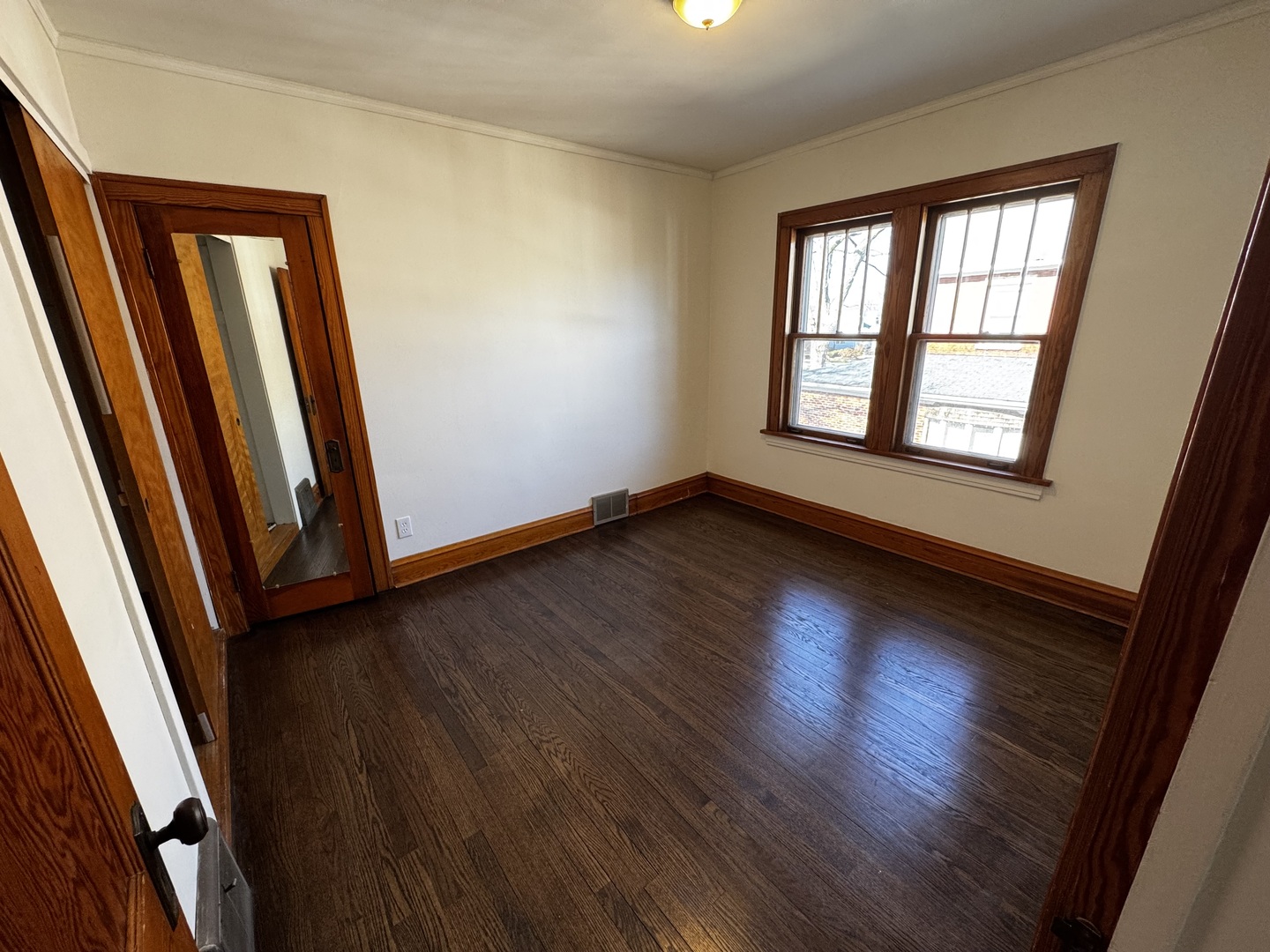 115 North Myrtle Avenue, Unit 2F Elmhurst, IL 60126 - Photo 6 of 14 an empty room with wooden floor and windows
