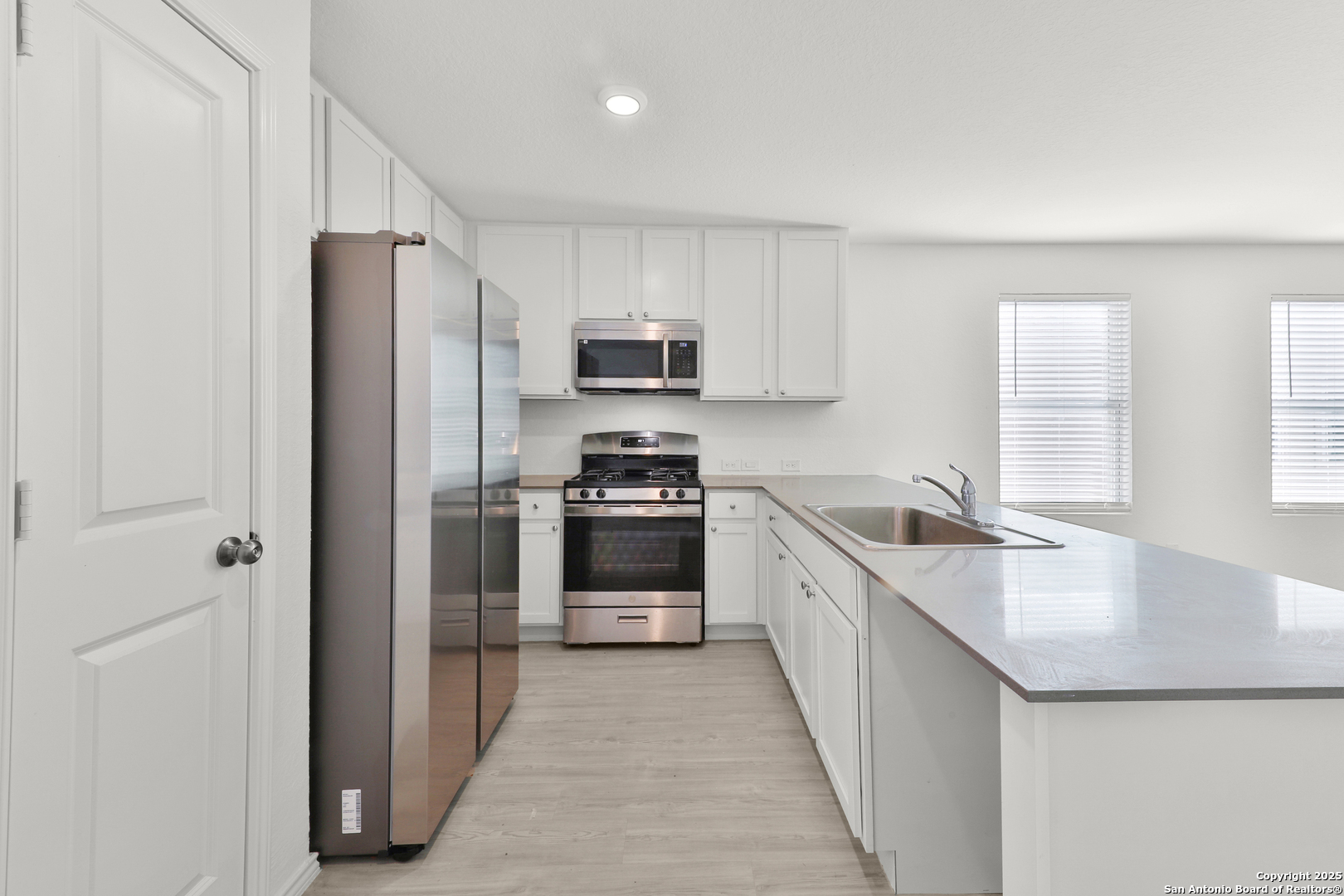 871 Landon Ridge San Antonio, TX 78253 - Photo 9 of 23 a kitchen with stainless steel appliances granite countertop a refrigerator sink and stove