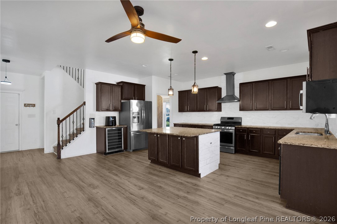 2145 Harrington Road Fayetteville, NC 28306 - Photo 18 of 50 a large kitchen with a center island wooden floor stainless steel appliances and cabinets