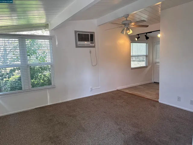 an empty room with windows and closet