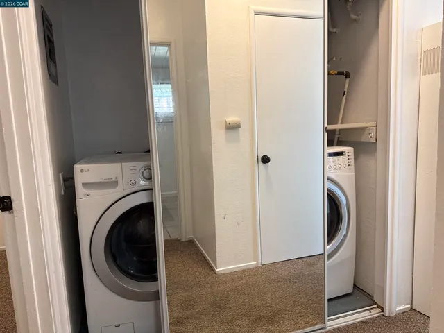 a view of a hallway with washer and dryer