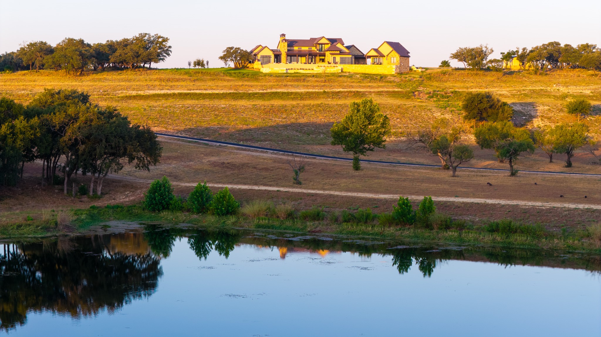 920 Ryan Road Bertram, TX 78605 - Photo 11 of 40 A striking hilltop estate overlooks a peaceful private pond on expansive acreage.