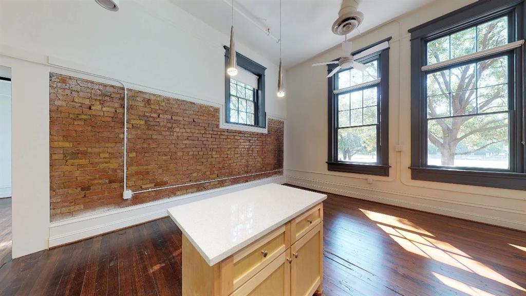 401 North Carroll Avenue, Unit 1101 Dallas, TX 75246 - Photo 4 of 5 a view of an empty room with wooden floor and a window