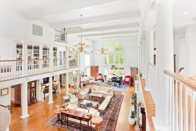 a view of a dining room with furniture wooden floor and a chandelier