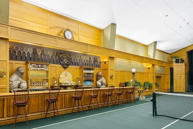 a living room with furniture chandelier and a fireplace