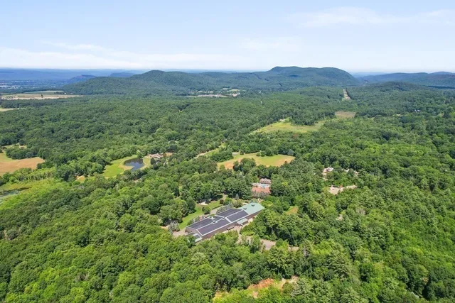 an aerial view of a house with a yard and lake view