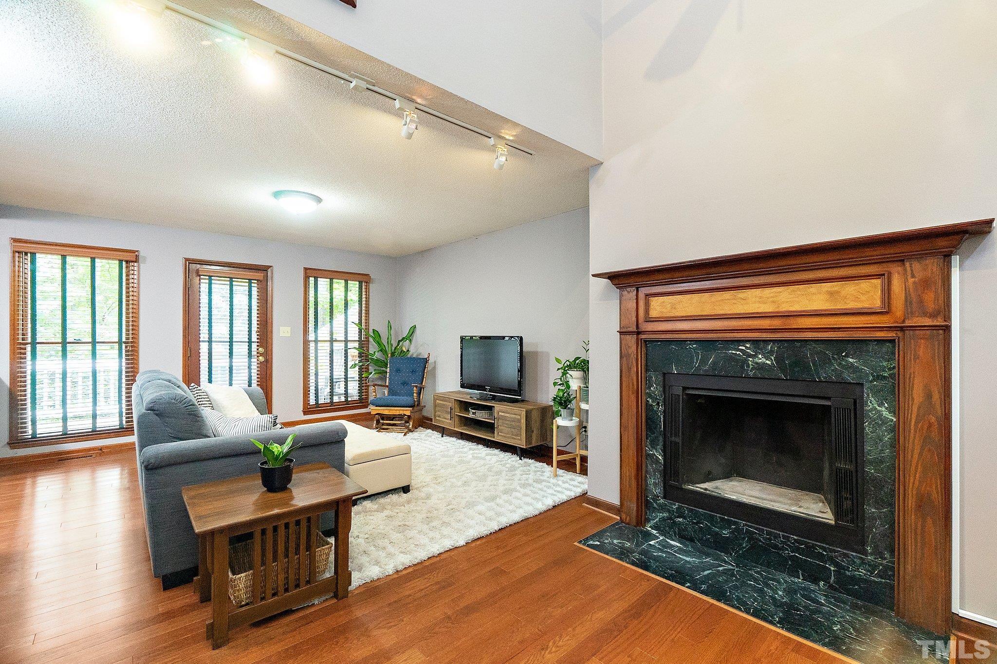 7838 Breckon Way Raleigh, NC 27615 - Photo 3 of 30 a living room with furniture and a fireplace