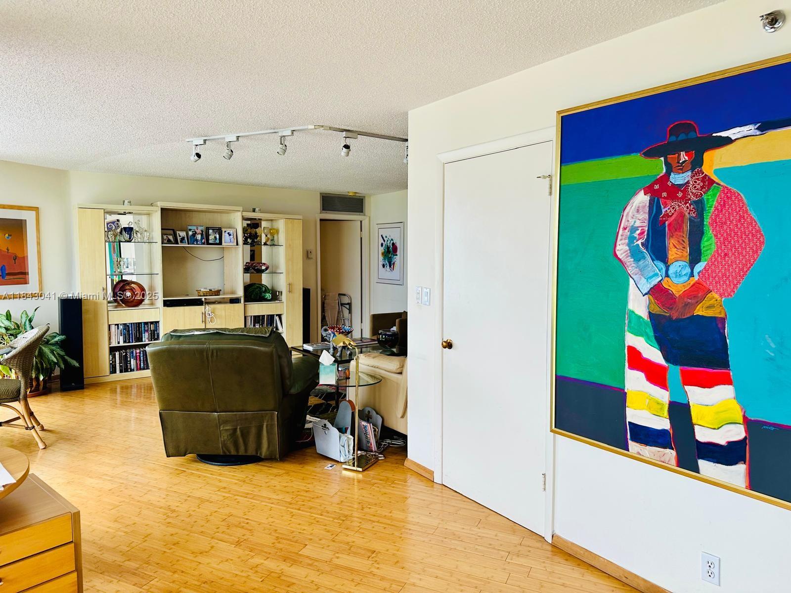 4000 Towerside Terrace, Unit 1503 Miami, FL 33138 - Photo 11 of 23 a living room with furniture and a flat screen tv