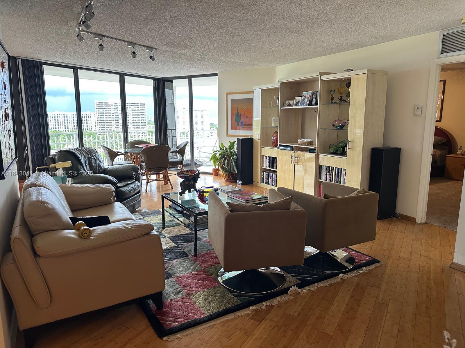 4000 Towerside Terrace, Unit 1503 Miami, FL 33138 - Photo 13 of 23 a living room with couch and a large window