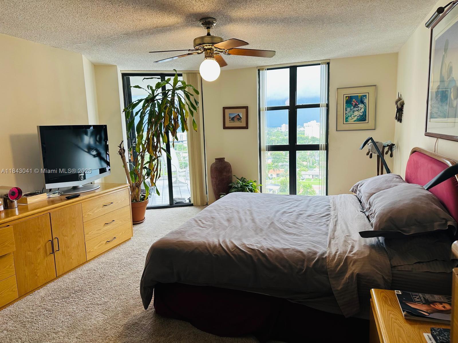 4000 Towerside Terrace, Unit 1503 Miami, FL 33138 - Photo 15 of 23 a bedroom with a bed and a flat screen tv