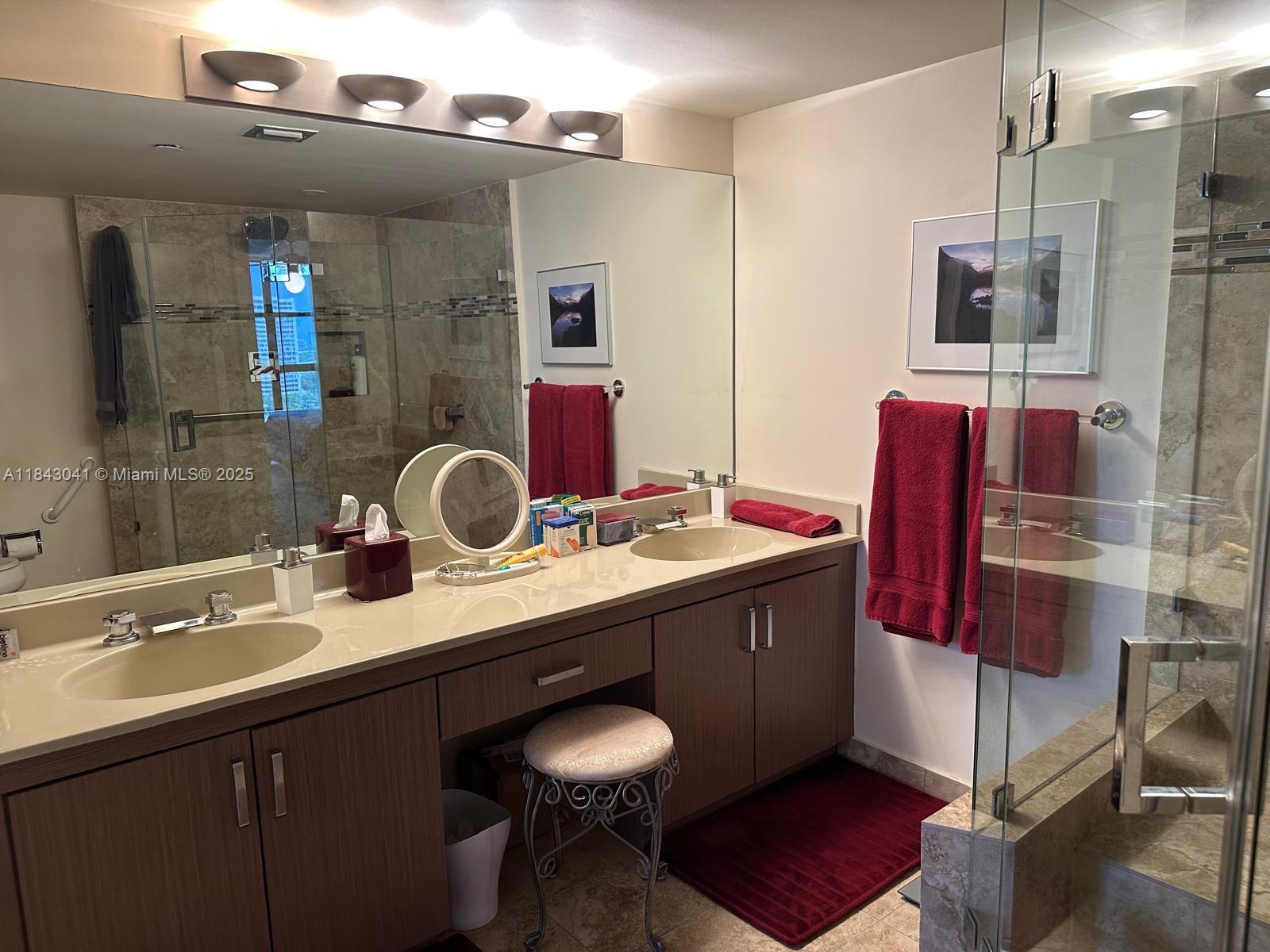 4000 Towerside Terrace, Unit 1503 Miami, FL 33138 - Photo 16 of 23 a bathroom with a sink double vanity and a mirror