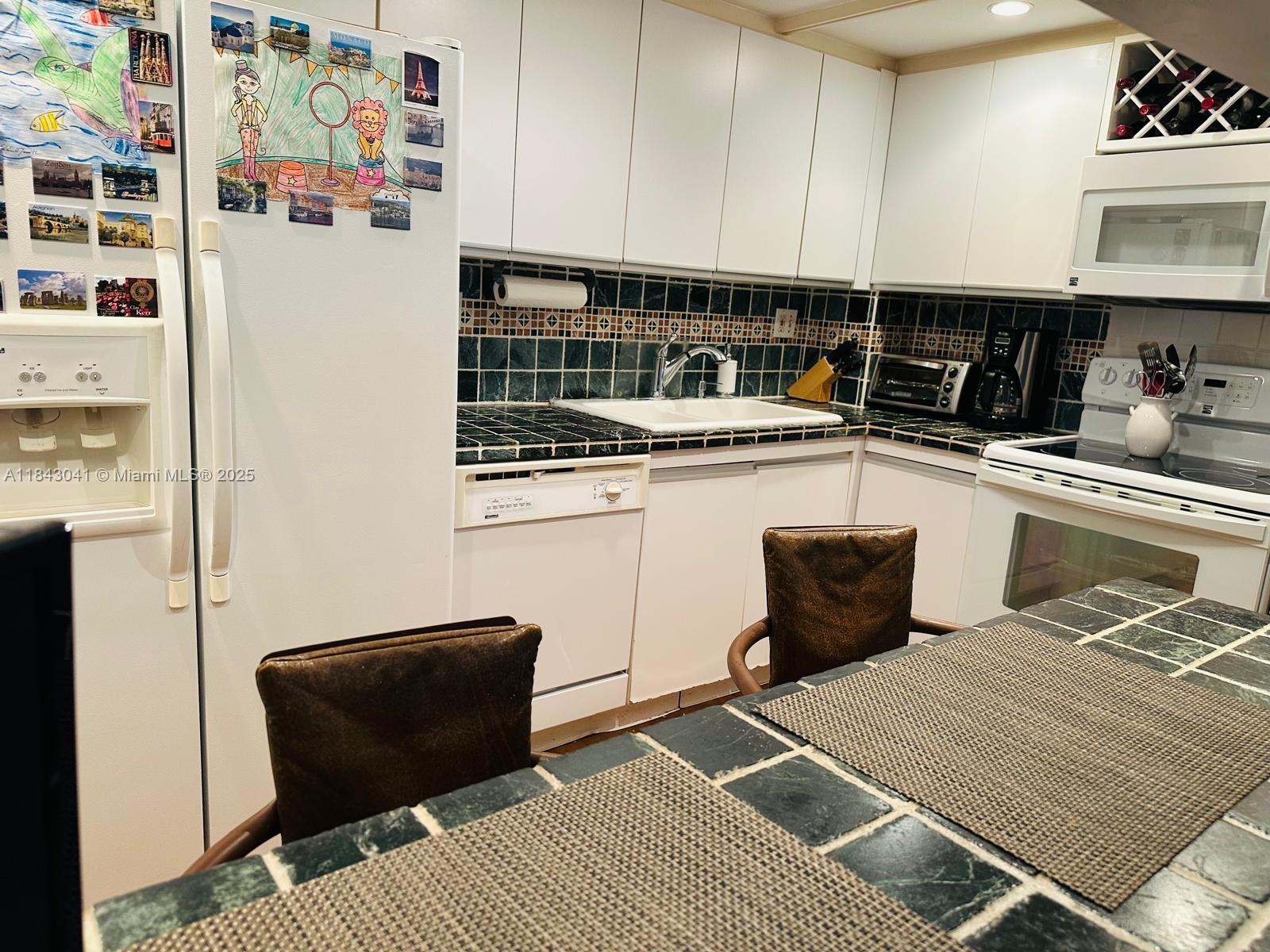 4000 Towerside Terrace, Unit 1503 Miami, FL 33138 - Photo 3 of 23 a kitchen with stainless steel appliances granite countertop a refrigerator and a stove top oven