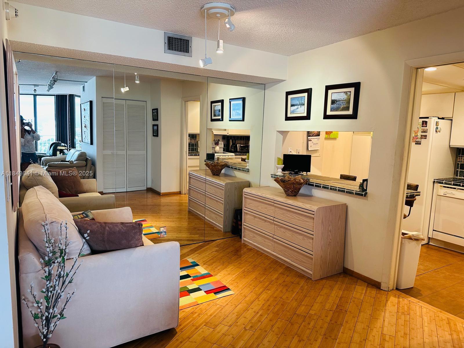 4000 Towerside Terrace, Unit 1503 Miami, FL 33138 - Photo 5 of 23 a living room with furniture and a flat screen tv
