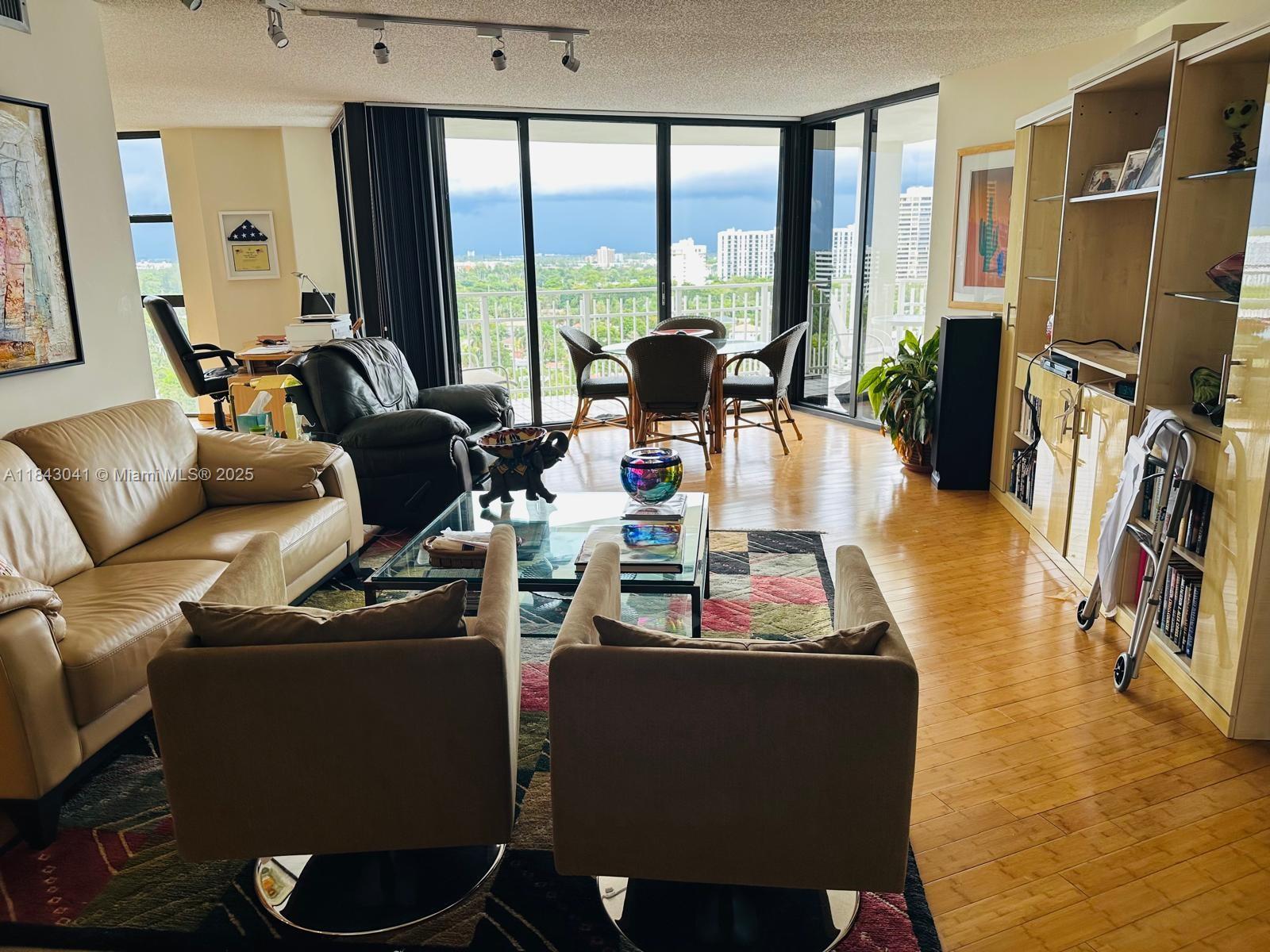 4000 Towerside Terrace, Unit 1503 Miami, FL 33138 - Photo 6 of 23 a living room with furniture and a large window