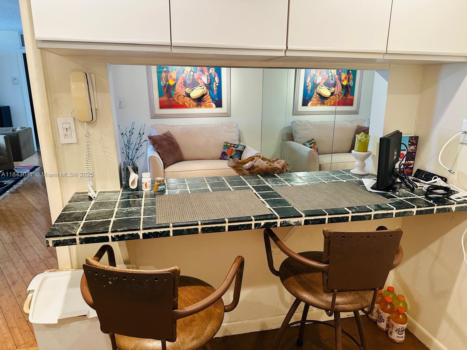 4000 Towerside Terrace, Unit 1503 Miami, FL 33138 - Photo 7 of 23 a living room with furniture a flat screen tv and a table