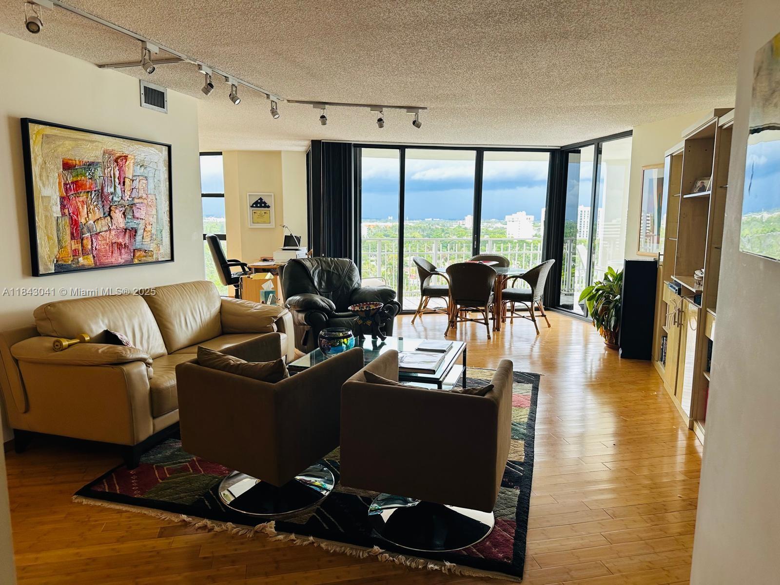 4000 Towerside Terrace, Unit 1503 Miami, FL 33138 - Photo 8 of 23 a living room with furniture large window and flat screen tv