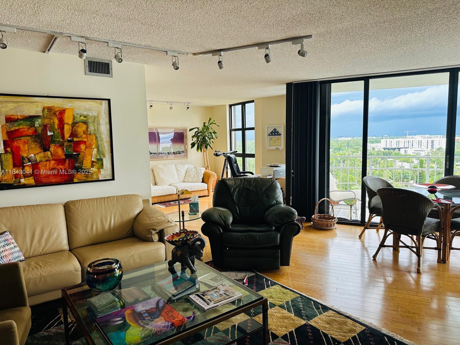 4000 Towerside Terrace, Unit 1503 Miami, FL 33138 - Photo 9 of 23 a living room with furniture and a large window