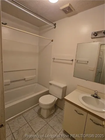 a bathroom with a sink a toilet and a shower