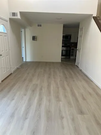 a view of empty room with furniture and closet
