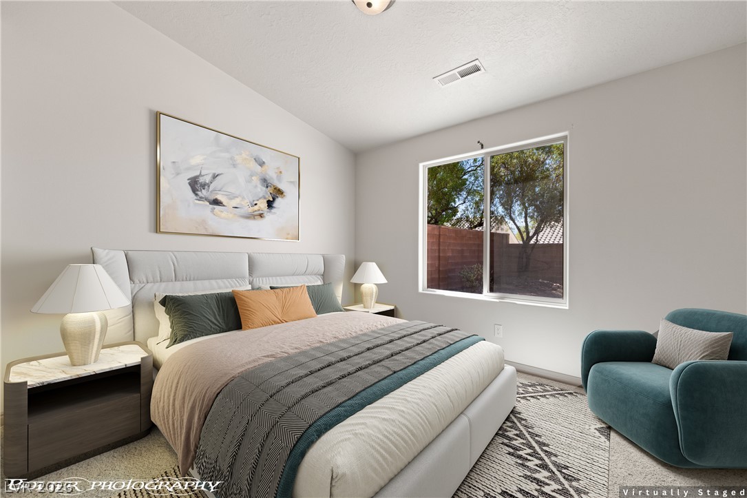 874 Glendale Road Mesquite, NV 89027 - Photo 48 of 71 A tranquil bedroom retreat features a well-lit window overlooking the yard, complemented by a soft carpet underfoot.