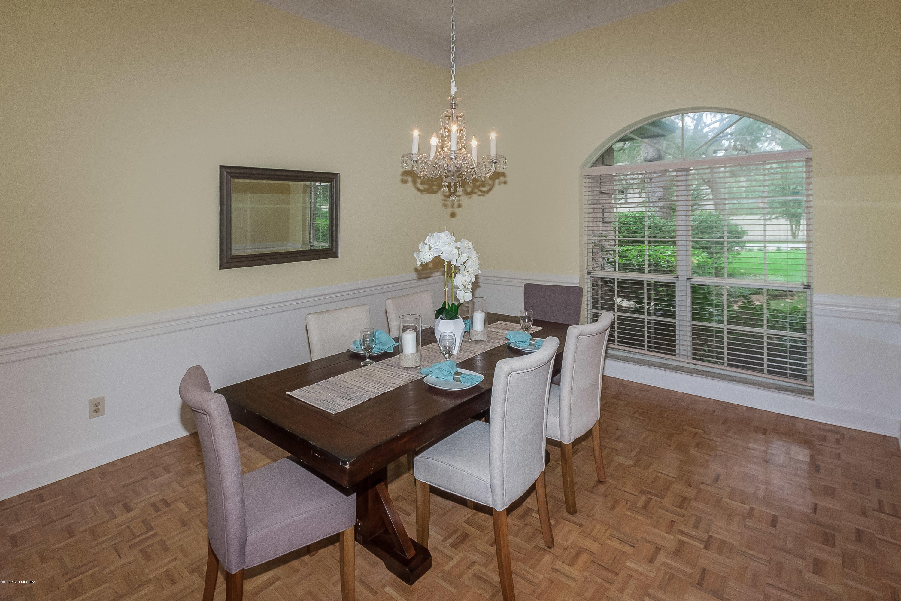 2720 Beauclerc Road Jacksonville, FL 32257 - Photo 14 of 45 a view of a dining room with furniture a chandelier and wooden floor
