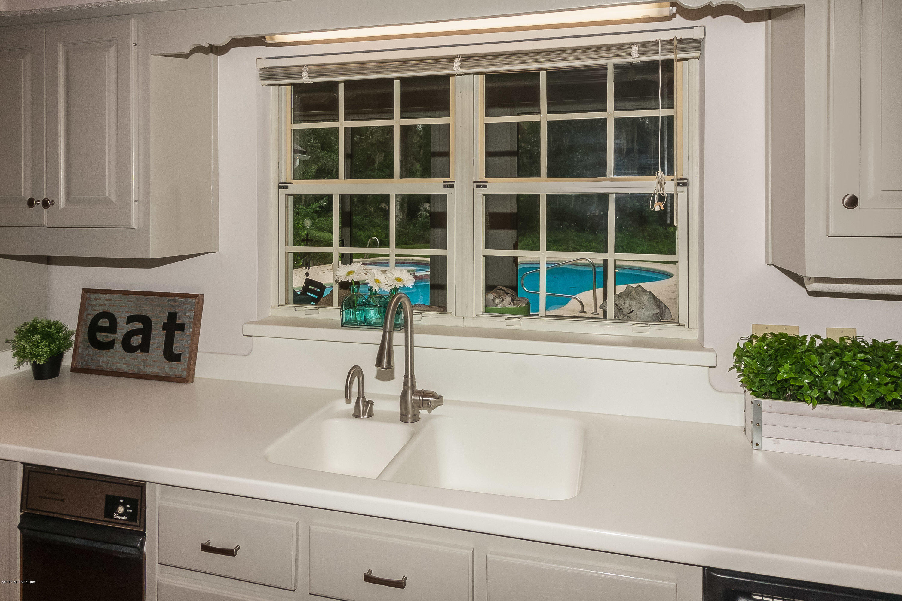 2720 Beauclerc Road Jacksonville, FL 32257 - Photo 23 of 45 a kitchen with a sink and a potted plant