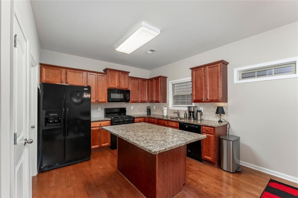 113 Tyson Woods Road Acworth, GA 30102 - Photo 13 of 37 a kitchen with granite countertop a refrigerator stove top oven and sink