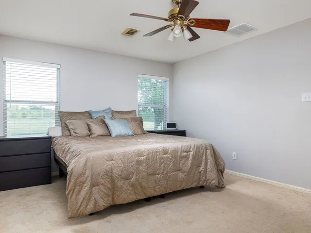 a bed sitting in a bedroom next to a window