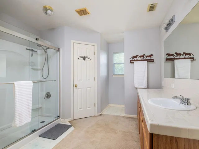a bathroom with a sink and shower