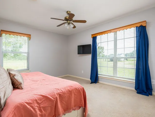 a bedroom with a large bed and a large window
