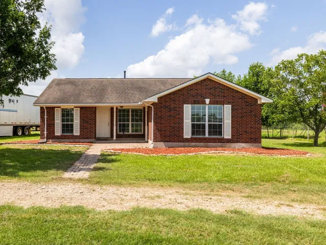 a front view of a house with a garden and porch