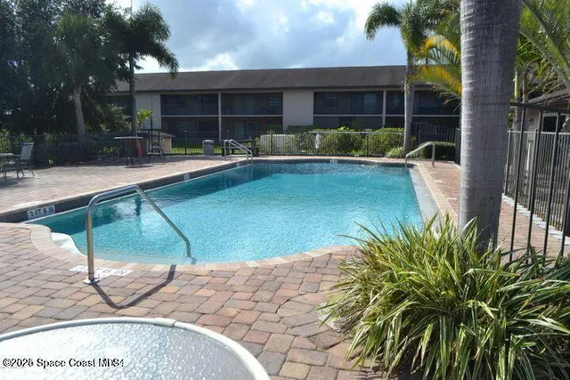 a swimming pool with outdoor seating and yard