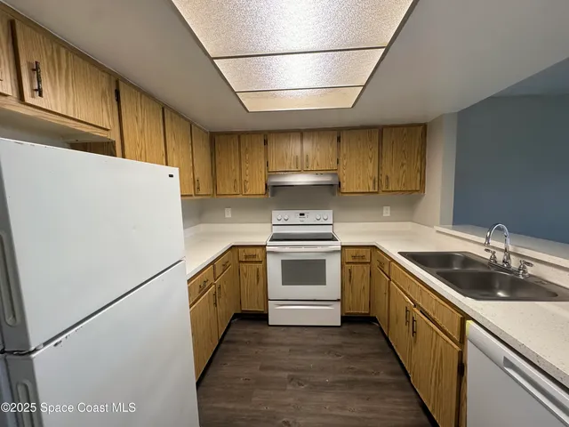 a kitchen with a sink a stove and refrigerator