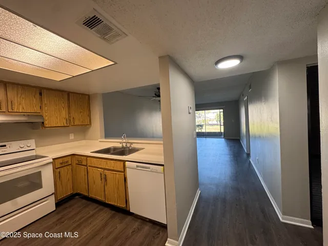 a kitchen with a sink cabinets stainless steel appliances and a window