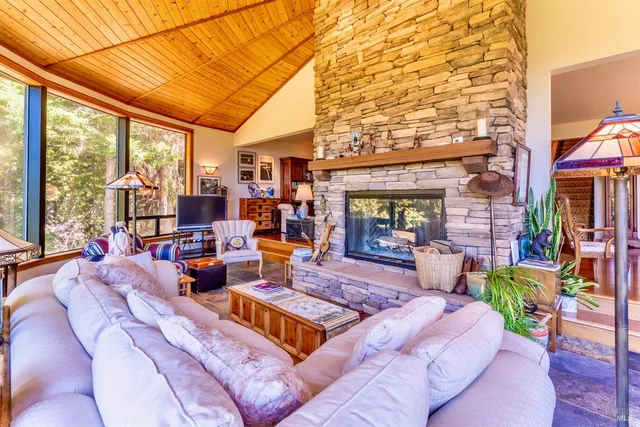 a living room with patio furniture and a fireplace