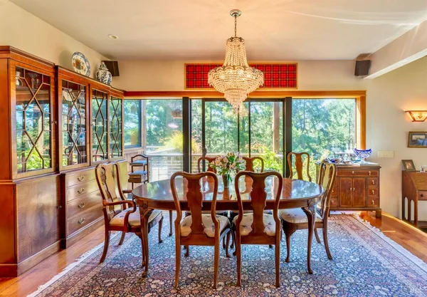 a dining room with furniture a fireplace and wooden floor